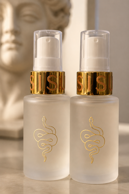 Two frosted glass cosmetic pump bottles with gold snake logos and metallic gold neck bands, shown on a light surface with a blurred classical bust in the background. Exosome rich serum with peptides for anti aging and skin firming