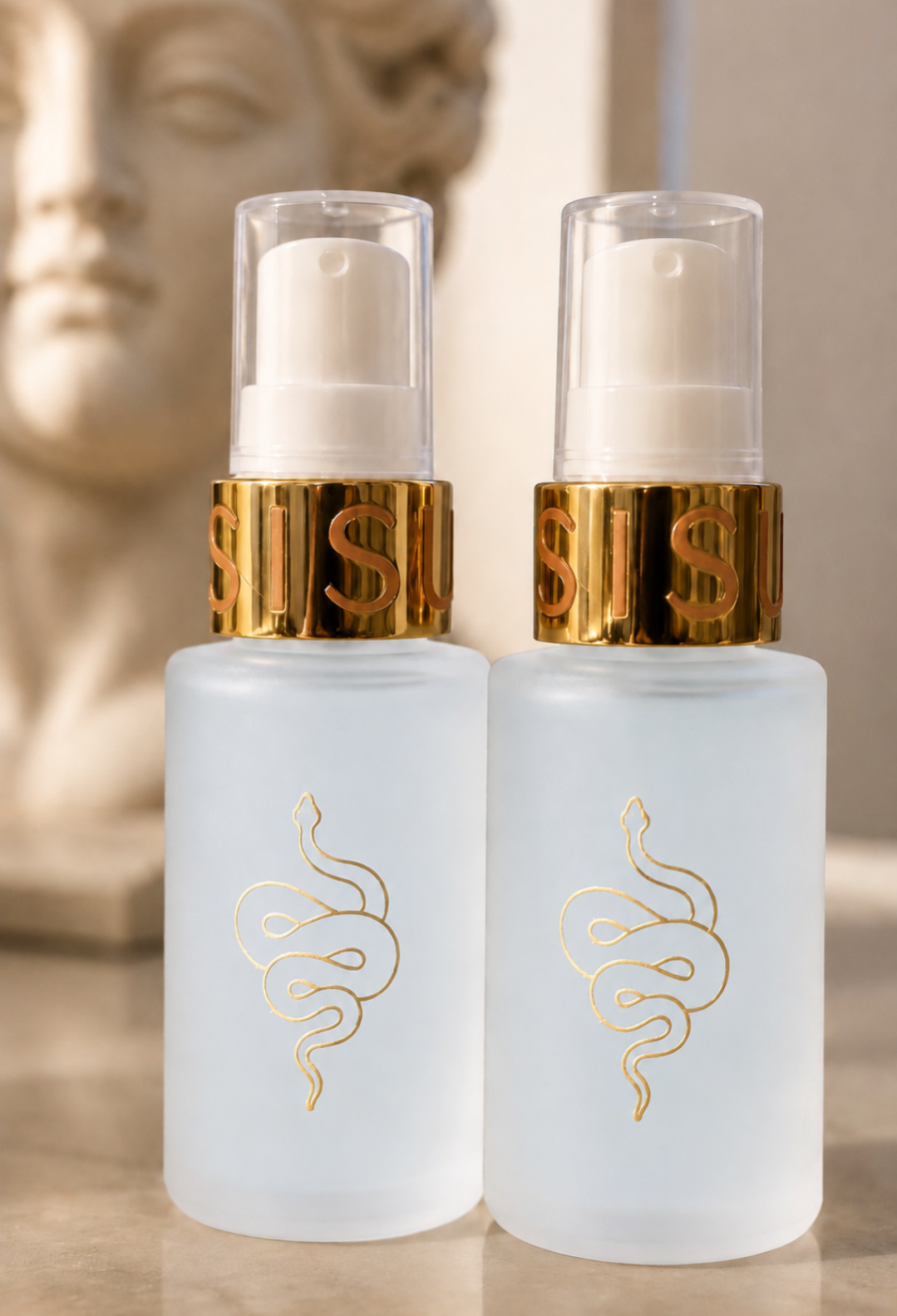 Two frosted glass pump bottles with gold snake logos and metallic gold collars, shown on a reflective surface with a blurred classical bust in the background. Peptide serum with copper and exosomes for skin firming, wound reparation and reduces fine lines. 