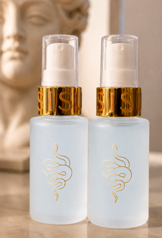 Two frosted glass pump bottles with gold snake logos and metallic gold collars, shown on a reflective surface with a blurred classical bust in the background. Peptide serum with copper and exosomes for skin firming, wound reparation and reduces fine lines. 