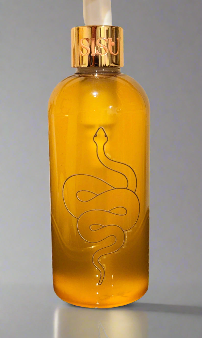 Yellow bottle with gold cap and snake design on a reflective surface. cellulite treatment, massage, in shower moisturise, eczema and dermatitis remdy