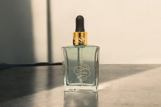 Luxury glass bottle with gold top and a snake illustration. this is a copper infused hyalauronic and niacinamide spray , essence and toner. This toner is perfect for acne prone skin 